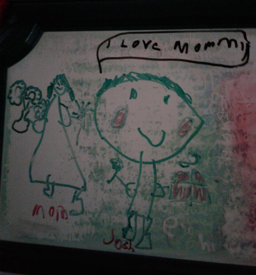 A photo of a child giving his mother flowers and a present, saying, "I love mommy."